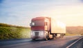 Truck with container on highway with sun light. Concept cargo transportation banner. Blur move effect