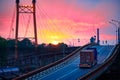 Truck with container rides on the road, railroad transportation, freight cars in industrial seaport at sunset Royalty Free Stock Photo