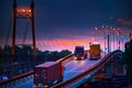 Truck with container rides on the road, railroad transportation, freight cars in industrial seaport at sunset Royalty Free Stock Photo