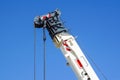 Truck crane detail boom with hooks and scale weight above blue sky Royalty Free Stock Photo
