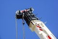 Truck crane detail boom with hooks and scale weight above blue sky Royalty Free Stock Photo