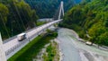 Truck crosses beautiful bridge in summer. Scene. Top view of truck carrying things driving across bridge on background