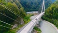 Truck crosses beautiful bridge in summer. Scene. Top view of truck carrying things driving across bridge on background