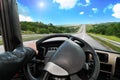 Truck dashboard with driver`s hand on the steering wheel on the