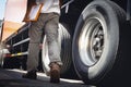 Truck Driver is Checking the Truck`s Safety Maintenance Checklist. Lorry. Inspection Semi Truck Wheels and Tires. Freight Trucks. Royalty Free Stock Photo