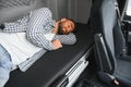 Truck driver enjoying comfortable cabin bed inside his truck Royalty Free Stock Photo