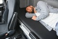 Truck driver enjoying comfortable cabin bed inside his truck Royalty Free Stock Photo