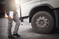 Truck driver holding clipboard his inspecting daily checklist safety of a truck wheels and tires. truck inspection and maintenance Royalty Free Stock Photo