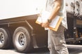Truck driver holding clipboard inspecting safety check a truck Royalty Free Stock Photo