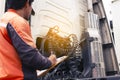 Truck driver holding clipboard inspecting safety vehicle maintenance checklist semi truck. Royalty Free Stock Photo