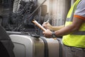 Truck driver inspecting safety fuel tank of semi truck. mechanic inspection diesel fuel tank. vehicle maintenance. Royalty Free Stock Photo