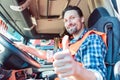 Truck driver sitting in cabin giving thumbs-up Royalty Free Stock Photo