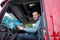 Truck driver in semi truck cab with modern dashboard Royalty Free Stock Photo