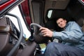 Truck driver sitting in cab of modern semi truck Royalty Free Stock Photo