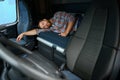 Truck driver sleeping on bed inside truck cabin interior. Trucker lifestyle. Royalty Free Stock Photo