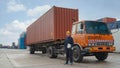 Truck driver standing by container truck at containers yard and cargo
