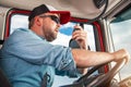 Truck Driver Taking Conversation Using CB Radio Royalty Free Stock Photo