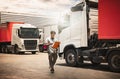 Truck Drivers Holding Clipboard Checking Truck Wheels Tires. Maintenance Checklist. Truck Inspection Safety Driving. Royalty Free Stock Photo