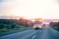 Truck driving on asphalt road in rural russia landscape with sun light, concept cargo transportation. Blur move effect