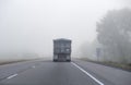 Truck Driving in Foggy Condition on Highway 401 in Early Morning Before Sunrise Royalty Free Stock Photo