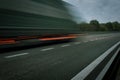 A truck driving on the highway at dawn. Blurred movement on the highway. Morning shot of a truck. Concept of Royalty Free Stock Photo