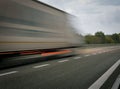 A truck driving on the highway at dusk. Motion blur on the highway. Evening shot of a truck. Concept of international Royalty Free Stock Photo