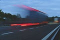 A truck driving on the highway at dusk. Motion blur on the highway. Evening shot of a truck. Concept of international Royalty Free Stock Photo