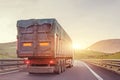 Truck driving on the road during sunset, evening trip