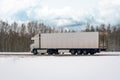 Truck driving on the winter road in rural landscape Royalty Free Stock Photo