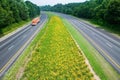 Truck driving on yellow flower lined state highway in rural Virginia