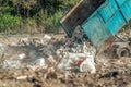 The truck dumps mixed waste at the landfill. Waste storage, ecological solutions