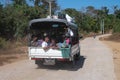 A truck filled with local people on an asphalt road close to Chaung Thar, Irrawaddy, Myanmar Royalty Free Stock Photo