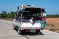 A truck filled with local people on an asphalt road close to Chaung Thar, Irrawaddy, Myanmar Royalty Free Stock Photo