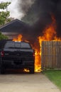 Out of control backyard fire consumes new truck. Royalty Free Stock Photo