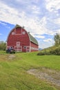 Truck in front of classic old red barn in Vermont