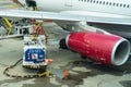 Truck with fuel tank on runway. Fuel truck refuel to the passenger plane. Workers Loading Bags Into plane. Oil truck Royalty Free Stock Photo