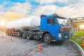 Truck fuel truck before unloading, with a trailer tank in the parking lot at a gas station. Royalty Free Stock Photo