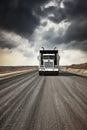 This truck, a giant among vehicles, carries the weight of commerce on its broad shoulders, ensuring goods reach their Royalty Free Stock Photo