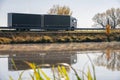 Truck goes on the road in autumn. car transport . Truck with semi-trailer in gray color. Transport truck drives in autumn by the Royalty Free Stock Photo