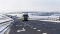 Truck goes on winter road. Van in the road of winter. Lorry car and cold landscape. Roadway and route snowy street trip