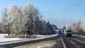 Truck goes on winter road. Van in the road of winter. Lorry car and cold landscape. Roadway and route snowy street trip