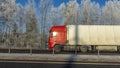 Truck goes on winter road. Van in the road of winter. Lorry car and cold landscape. Roadway and route snowy street trip.