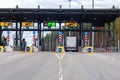 Truck going through toll plaza gate at toll road