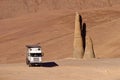 Truck and a hand sculpture in the desert