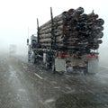 Truck Hauling Logs in Winter Storm Royalty Free Stock Photo