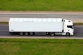 Truck on highway in motion, side view. Commercial cargo van, freight car