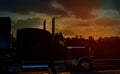 Truck highway road with transporting on the asphalt expressway against sky during sunset