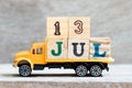 Truck hold block in word 13jul on wood background Concept for date 13 month July