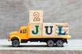 Truck hold block in word 2jul on wood background Concept for date 2 month July