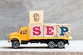 Truck hold block in word 9sep on wood background Concept for date 9 month september